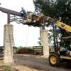 The metal art is being installed.